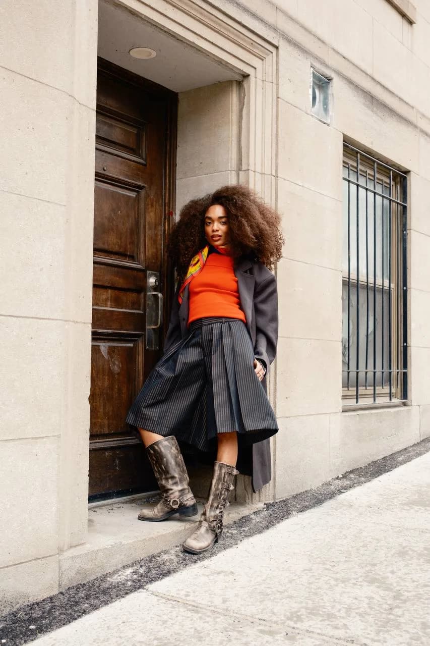 Full body styling of the shell scarf with an orange top and structured skirt