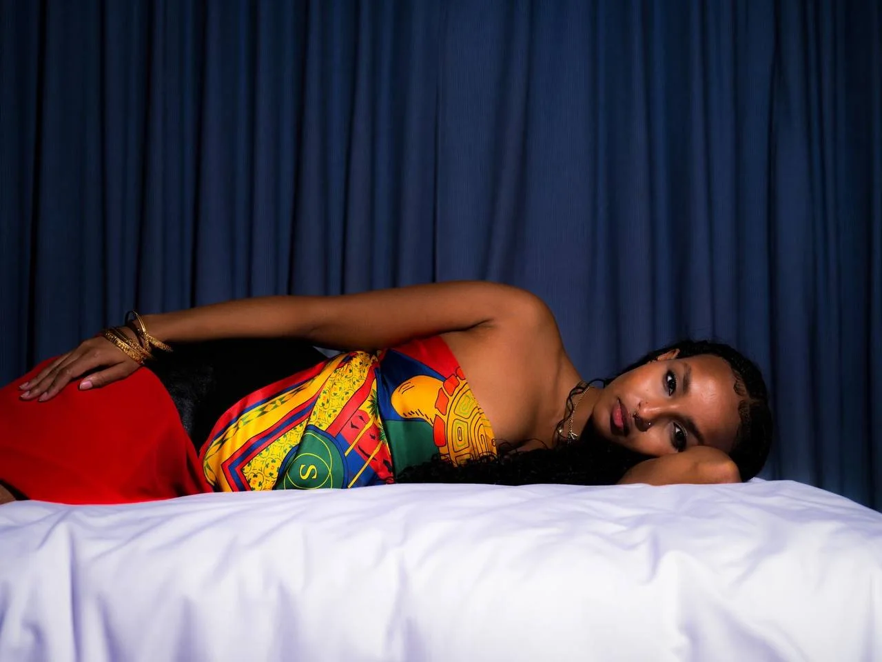 Model reclining with the shell scarf wrapped as a top