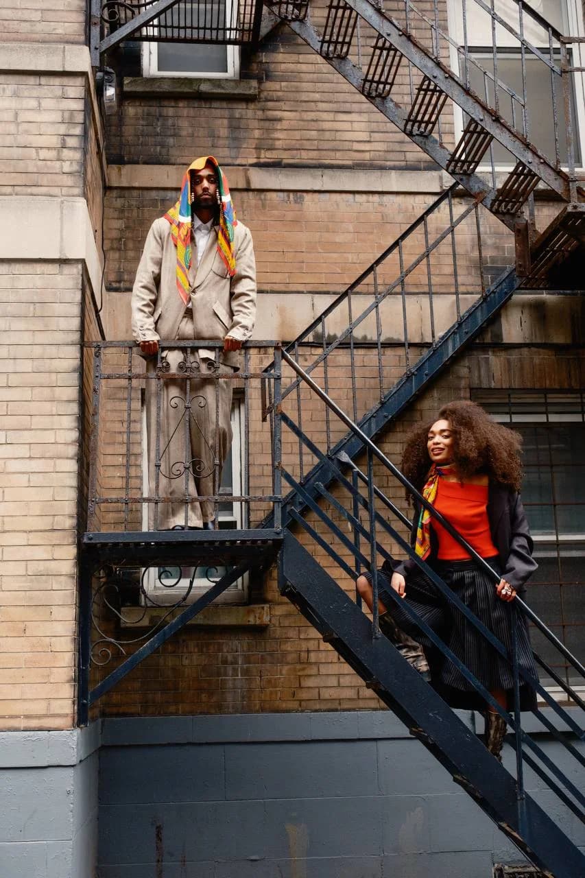 Two models styling shell scarves on a city fire escape