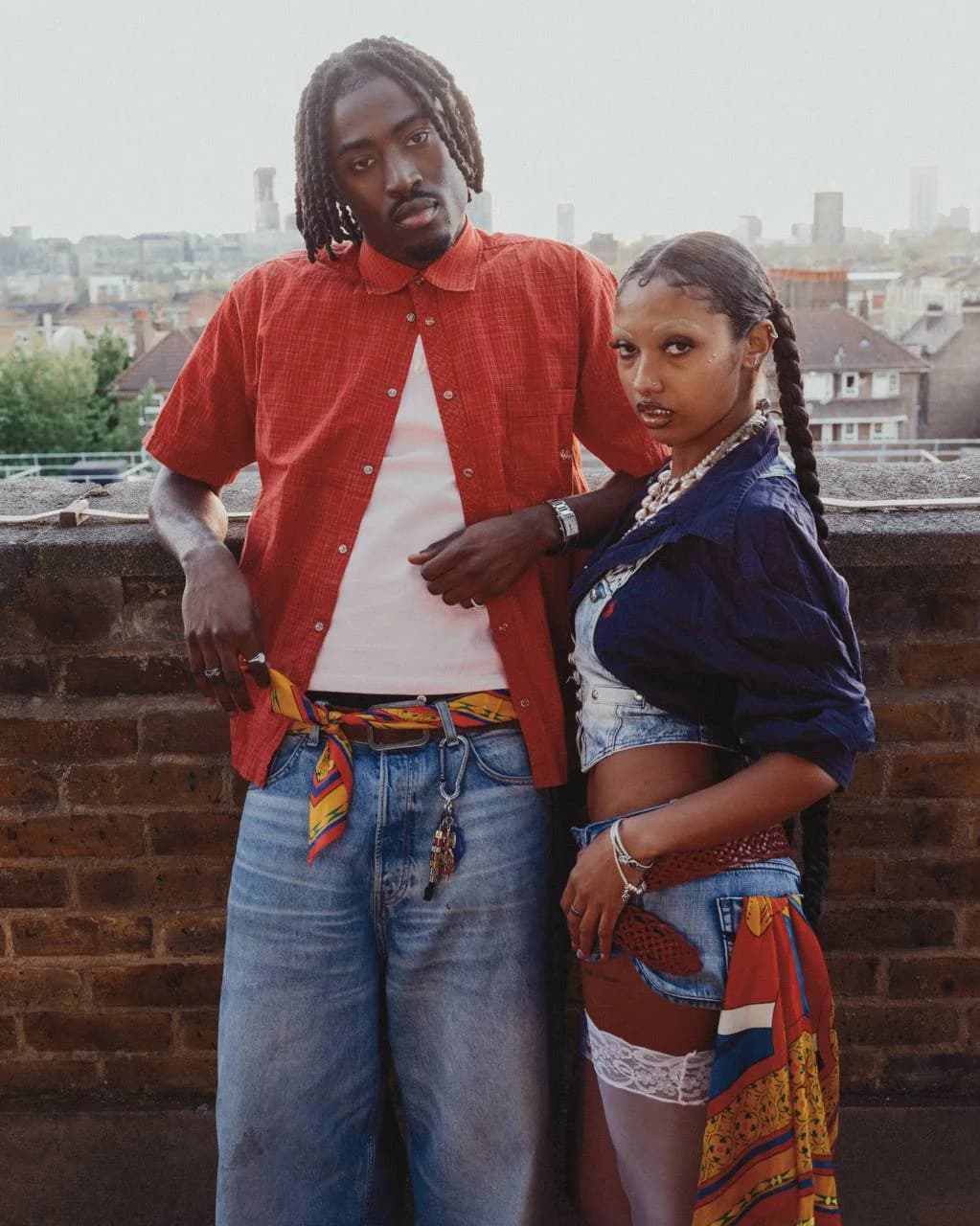 Two models styling the Art Beyond The Shell shell scarf on a rooftop